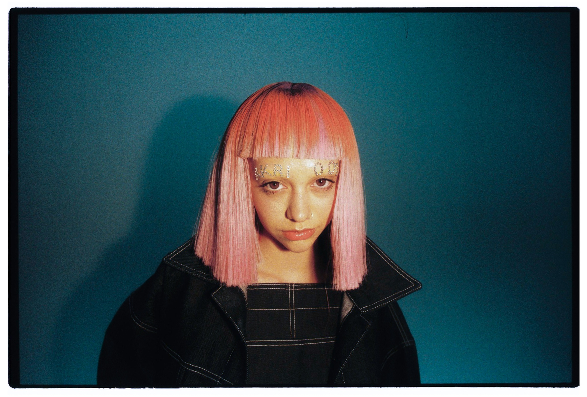 Retrato editorial de una artista con cabello rosado